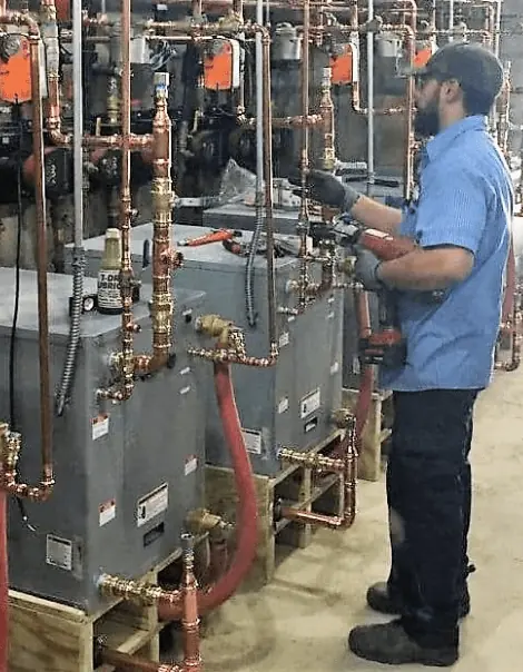 Home 3 Kahn Mechanical technician servicing commercial HVAC equipment